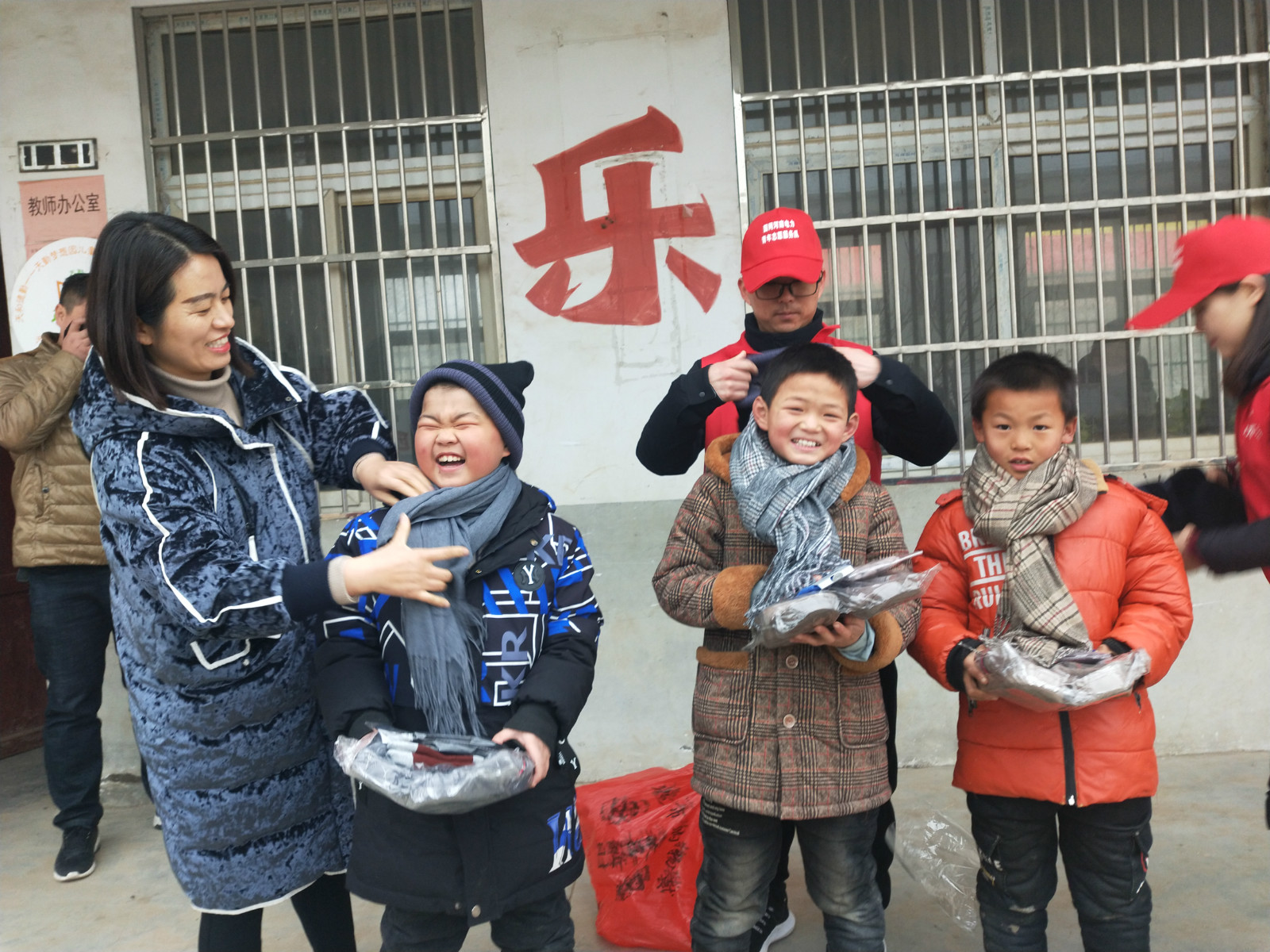 图为志愿者为孩子们戴围巾 中国青年报通讯员卢昊供图_meitu_1.jpg